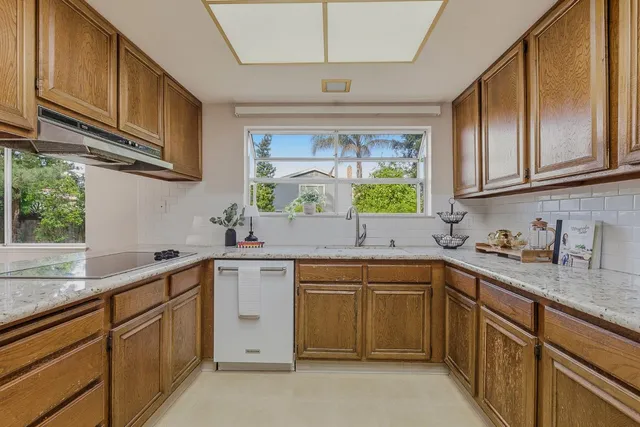 a kitchen with a sink stove and cabinets