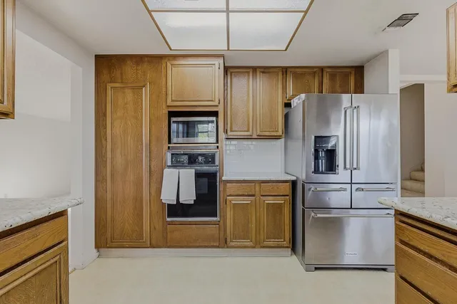 a kitchen with stainless steel appliances a refrigerator and a stove