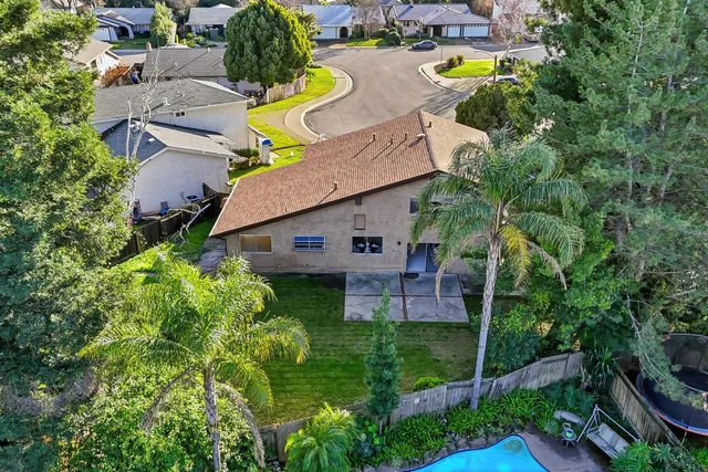 an aerial view of a house with garden space and street view