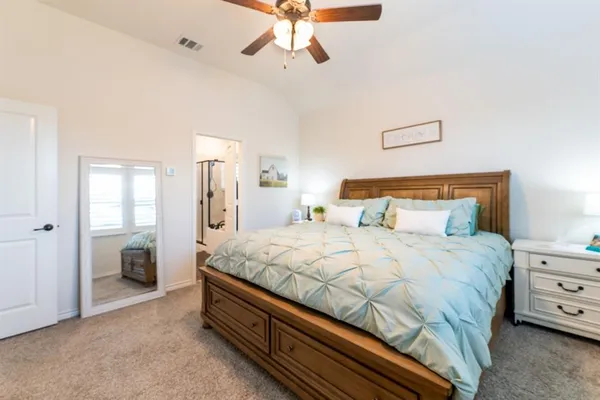 a bedroom with a bed and a chandelier