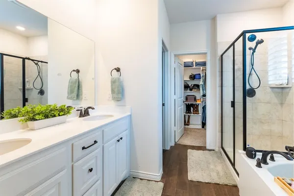 a bathroom with a double vanity sink and mirror
