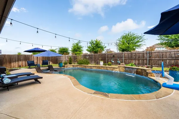 a view of swimming pool with seating space