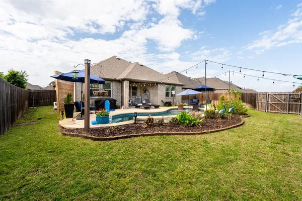 a view of a house with a backyard porch and sitting area