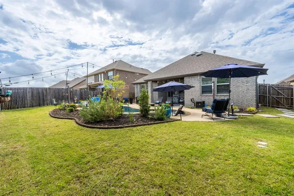 a view of a house with swimming pool and sitting area