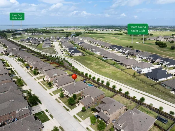 an aerial view of a city with lots of residential buildings ocean and mountain view in back