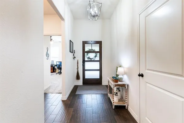 a hallway with wooden floor windows and livingroom