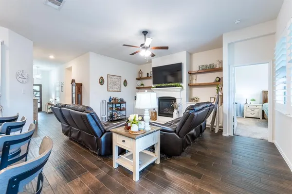 a living room with furniture a fireplace and a flat screen tv