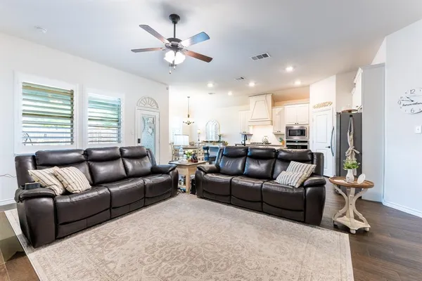 a living room with furniture kitchen and a window