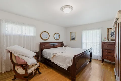 a bedroom with a bed and a chair