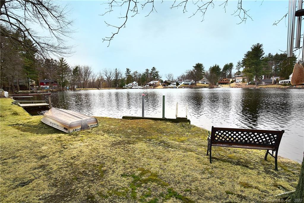 a view of a lake with a bench and trees