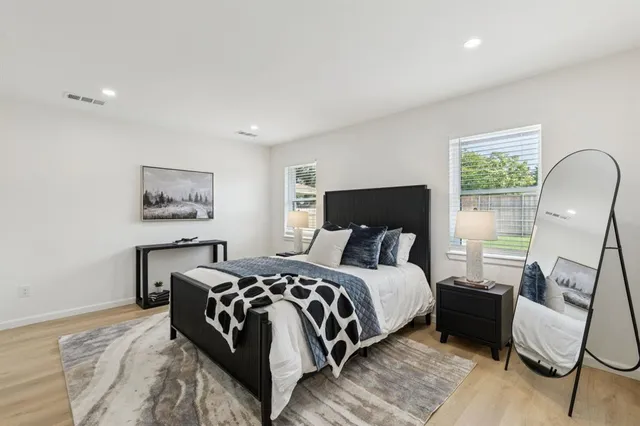 a bedroom with a bed a couch and dresser