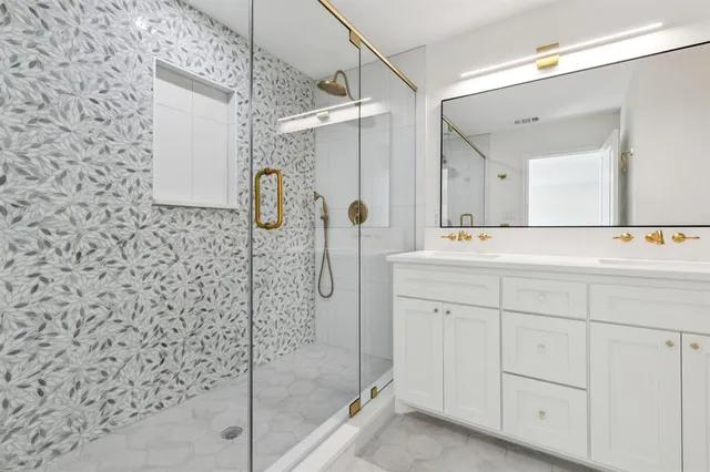 a bathroom with a shower sink and mirror