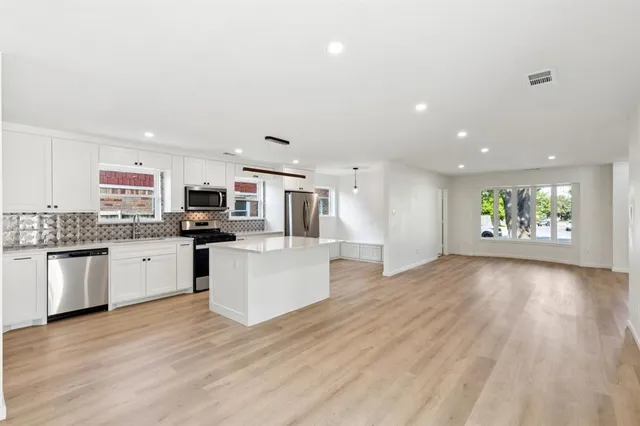 a view of a kitchen with microwave and stove top oven