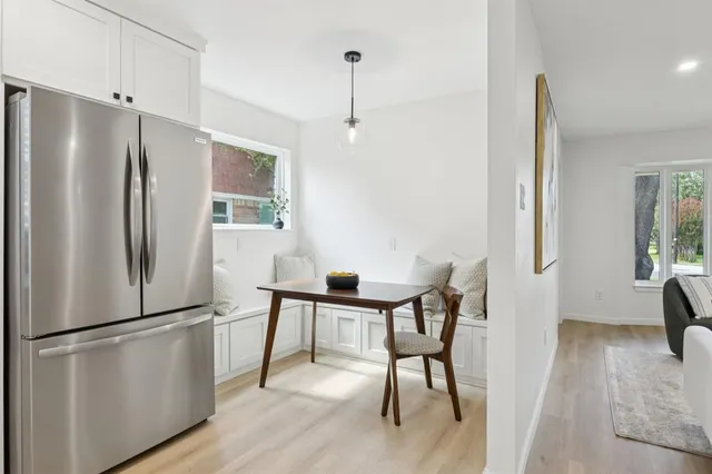 a kitchen with stainless steel appliances a refrigerator and a table