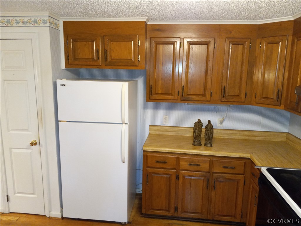 2964 West Creek Road Crewe, VA 23930 - Photo 8 of 46 a kitchen with a refrigerator and cabinets