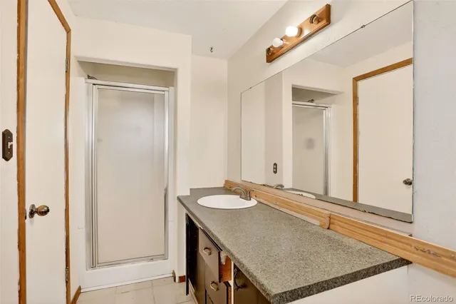 a view of a room with a ceiling fan and a window