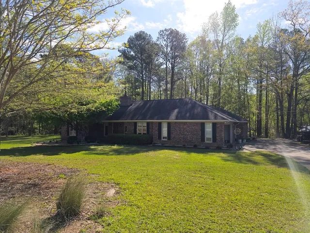 a white house with a large pool in front of it