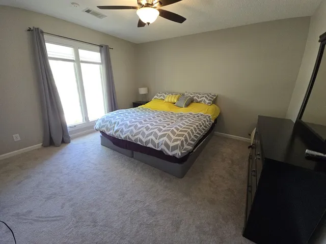 a bedroom with a bed and a chandelier
