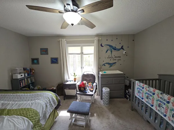 a bedroom with a bed and a chandelier