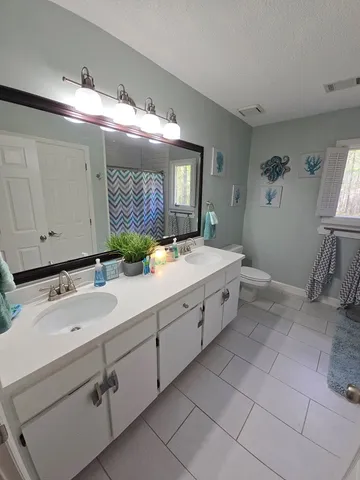 a bathroom with a double vanity sink and mirror