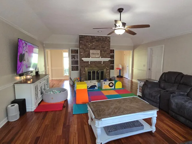 a living room with furniture fireplace and flat screen tv