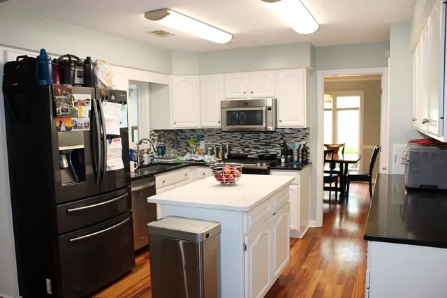 a kitchen with a refrigerator stove and sink