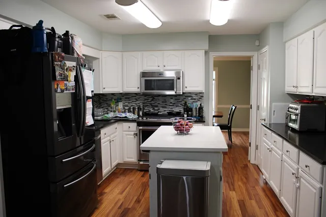 a kitchen with a sink stove and refrigerator