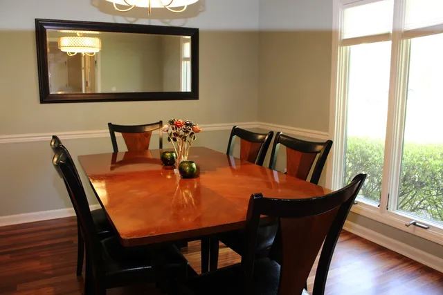 a view of a dining room with furniture and wooden floor