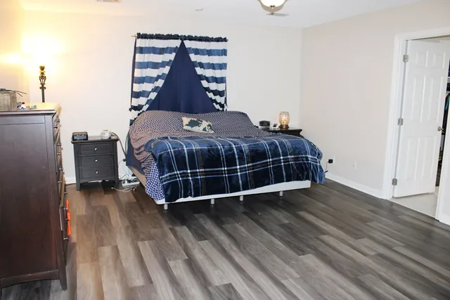 a bedroom with a bed and a dresser