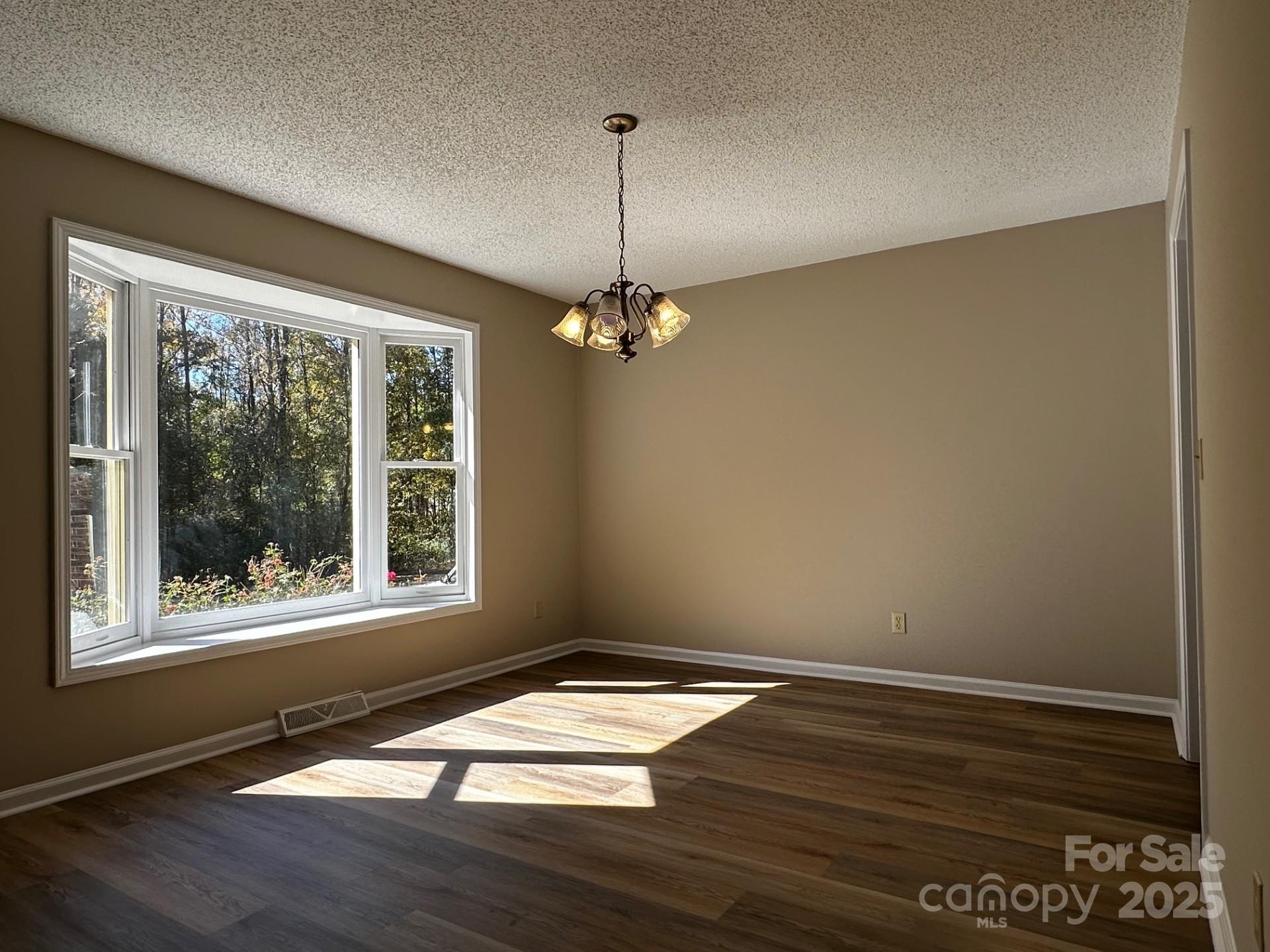 1080 Gin Road Rockwell, NC 28138 - Photo 11 of 34 a view of empty room with wooden floor and fan