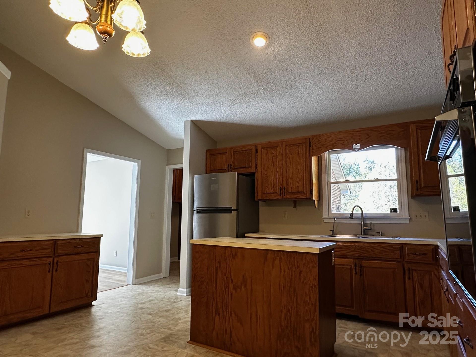 1080 Gin Road Rockwell, NC 28138 - Photo 13 of 34 a kitchen with granite countertop a refrigerator and a sink