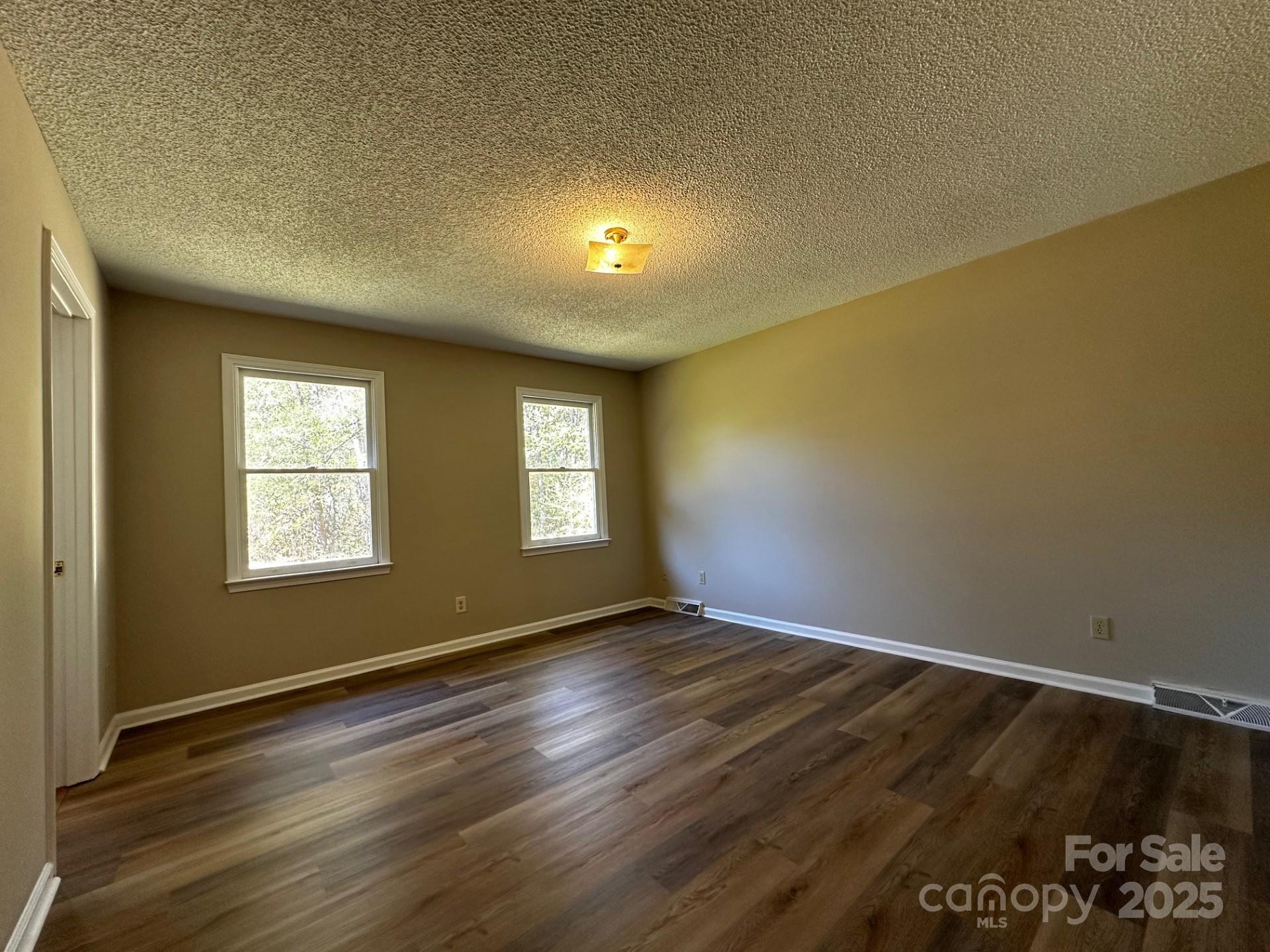 1080 Gin Road Rockwell, NC 28138 - Photo 17 of 34 a view of an empty room with wooden floor and a window