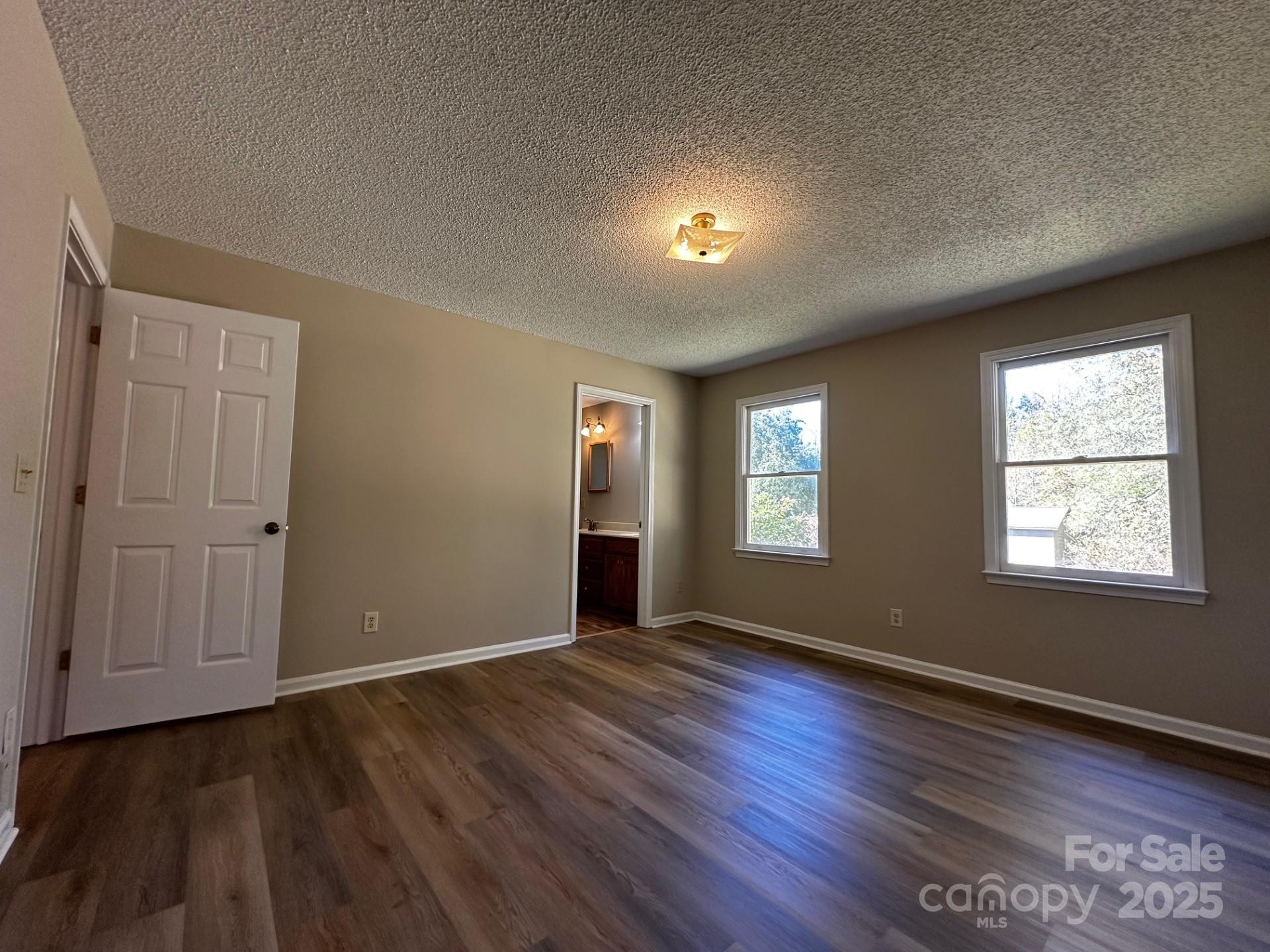 1080 Gin Road Rockwell, NC 28138 - Photo 18 of 34 an empty room with wooden floor and windows