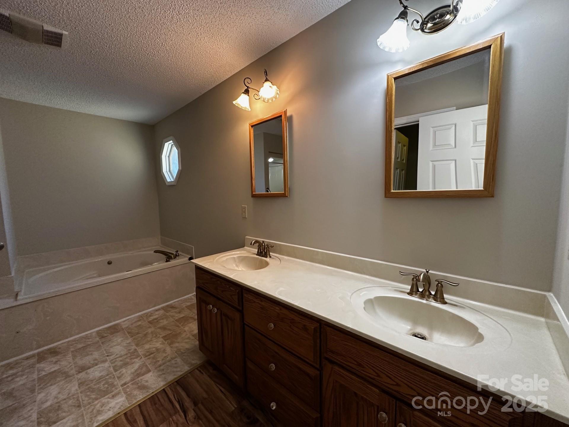 1080 Gin Road Rockwell, NC 28138 - Photo 20 of 34 a bathroom with a tub sink and mirror