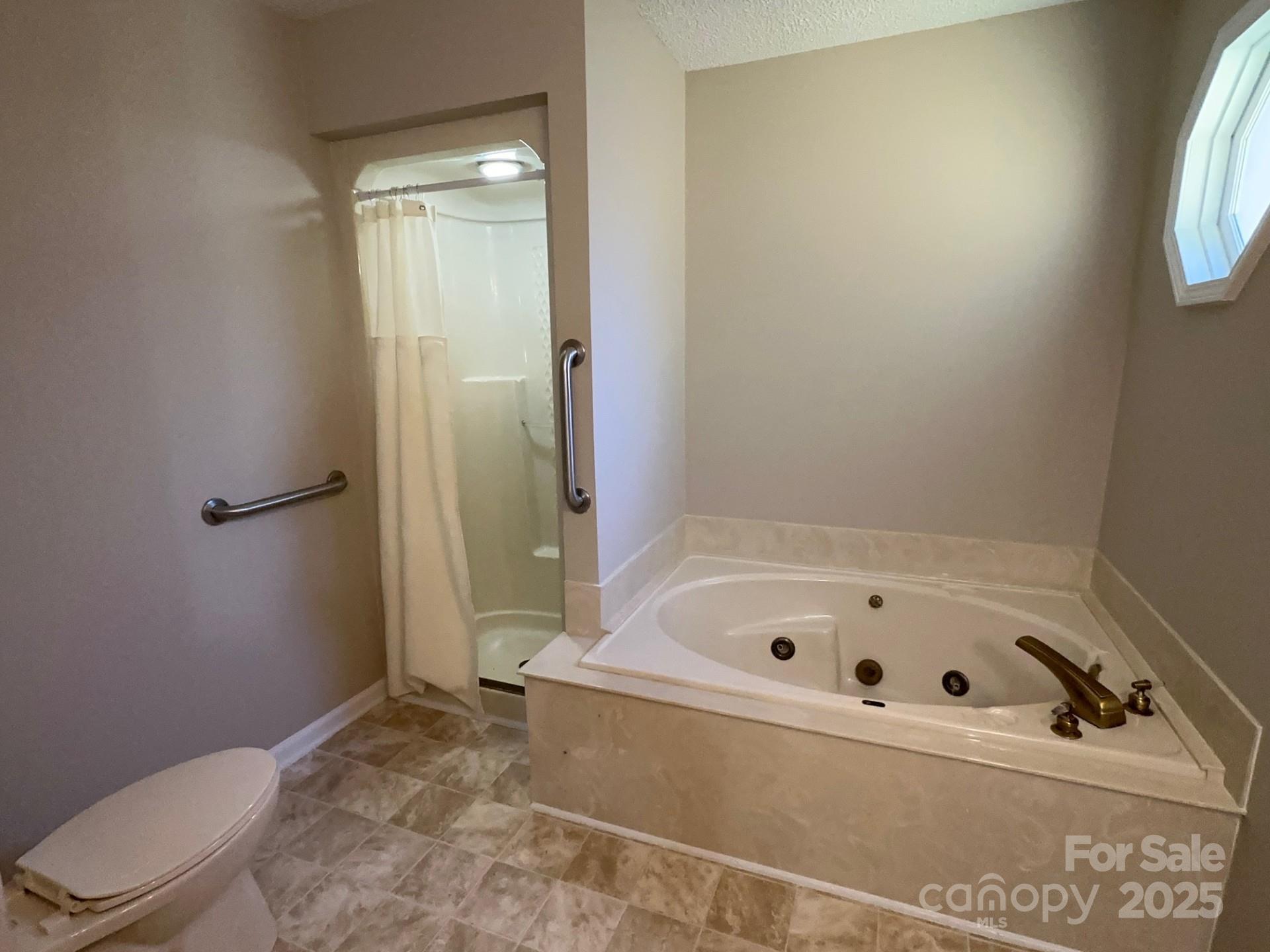 1080 Gin Road Rockwell, NC 28138 - Photo 21 of 34 a bathroom with a bathtub and a toilet
