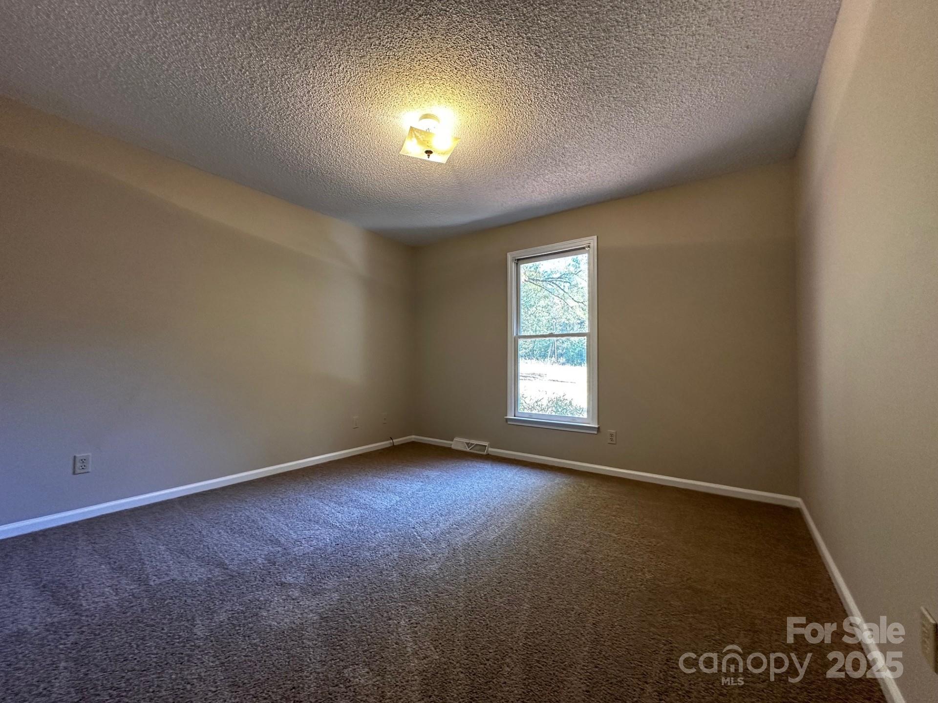 1080 Gin Road Rockwell, NC 28138 - Photo 23 of 34 an empty room with a window