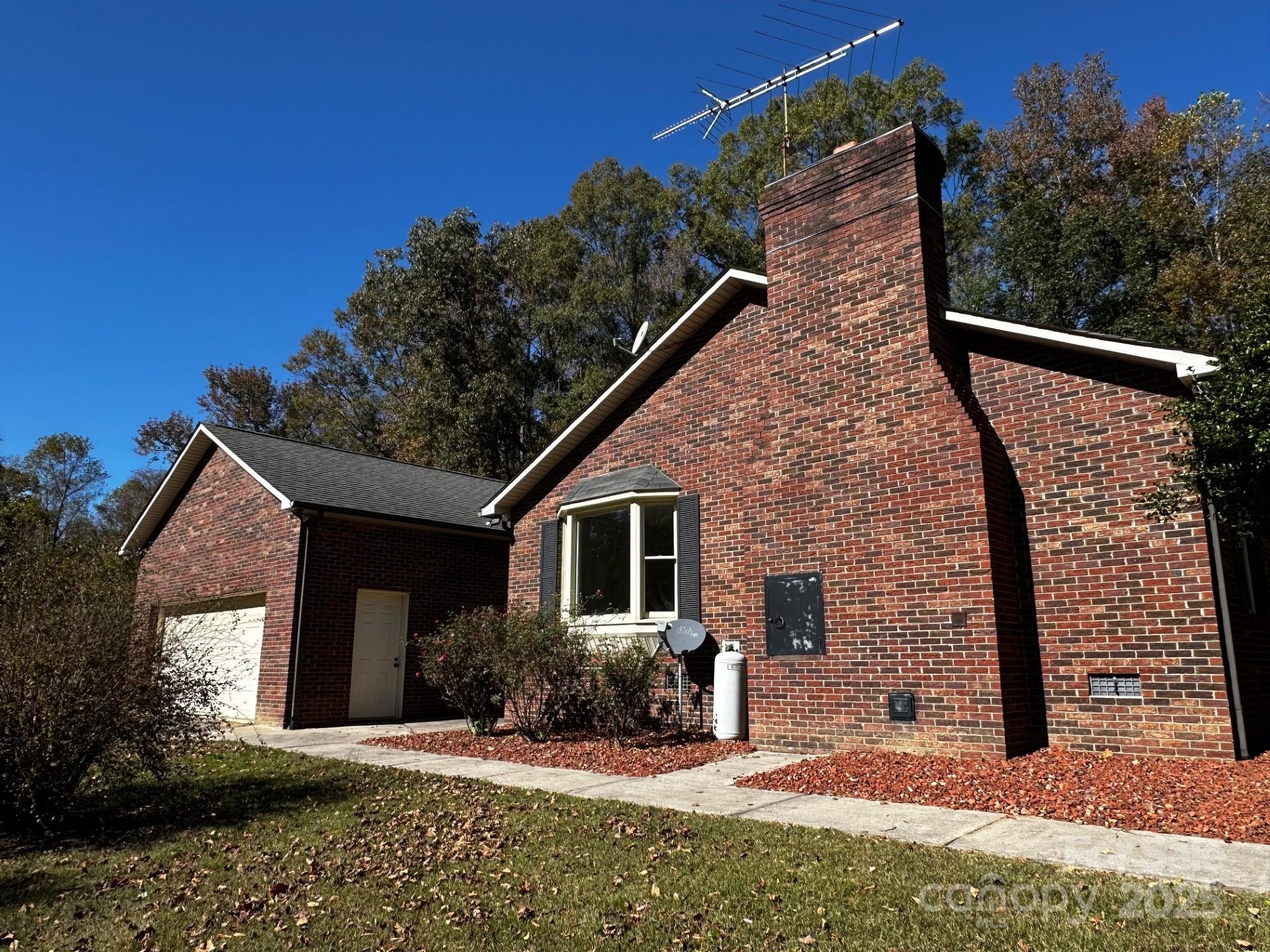 1080 Gin Road Rockwell, NC 28138 - Photo 26 of 34 a view of a house with brick walls plants and large tree