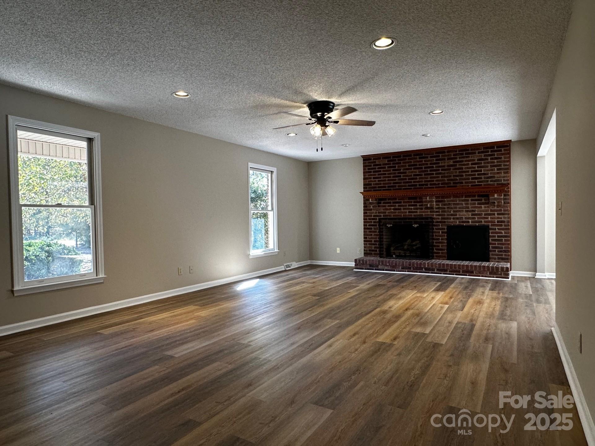 1080 Gin Road Rockwell, NC 28138 - Photo 7 of 34 an empty room with windows and fireplace