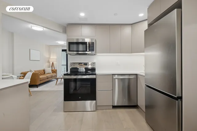 a kitchen with stainless steel appliances a refrigerator stove and microwave
