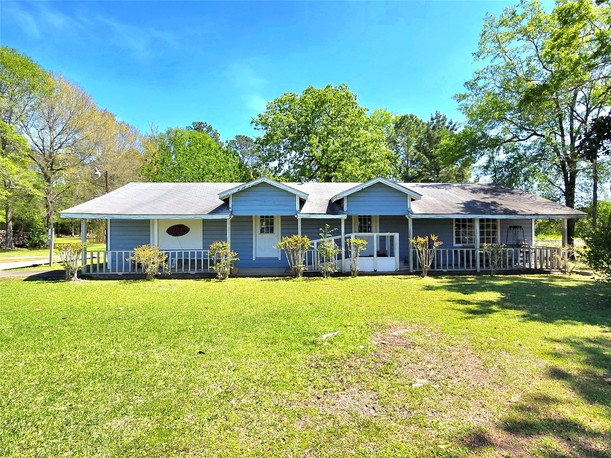 620 Easy Street Cleveland, TX 77327 - Photo 1 of 26 a front view of a house with a garden