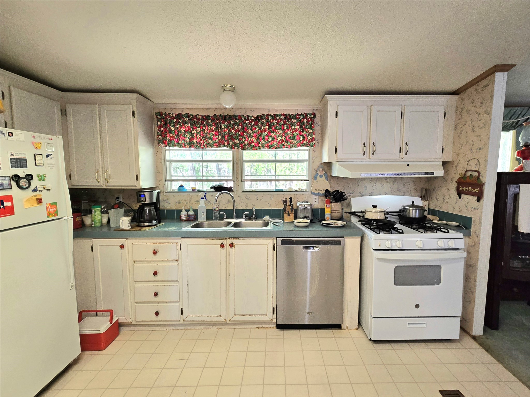 620 Easy Street Cleveland, TX 77327 - Photo 12 of 26 a kitchen with granite countertop white cabinets sink and white appliances