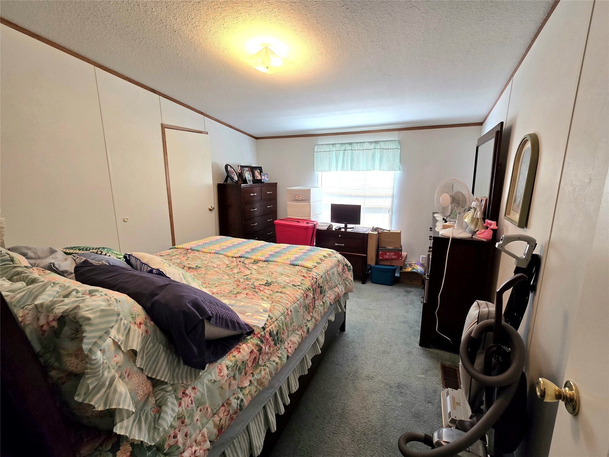 620 Easy Street Cleveland, TX 77327 - Photo 15 of 26 a bed room with a bed tv and a window