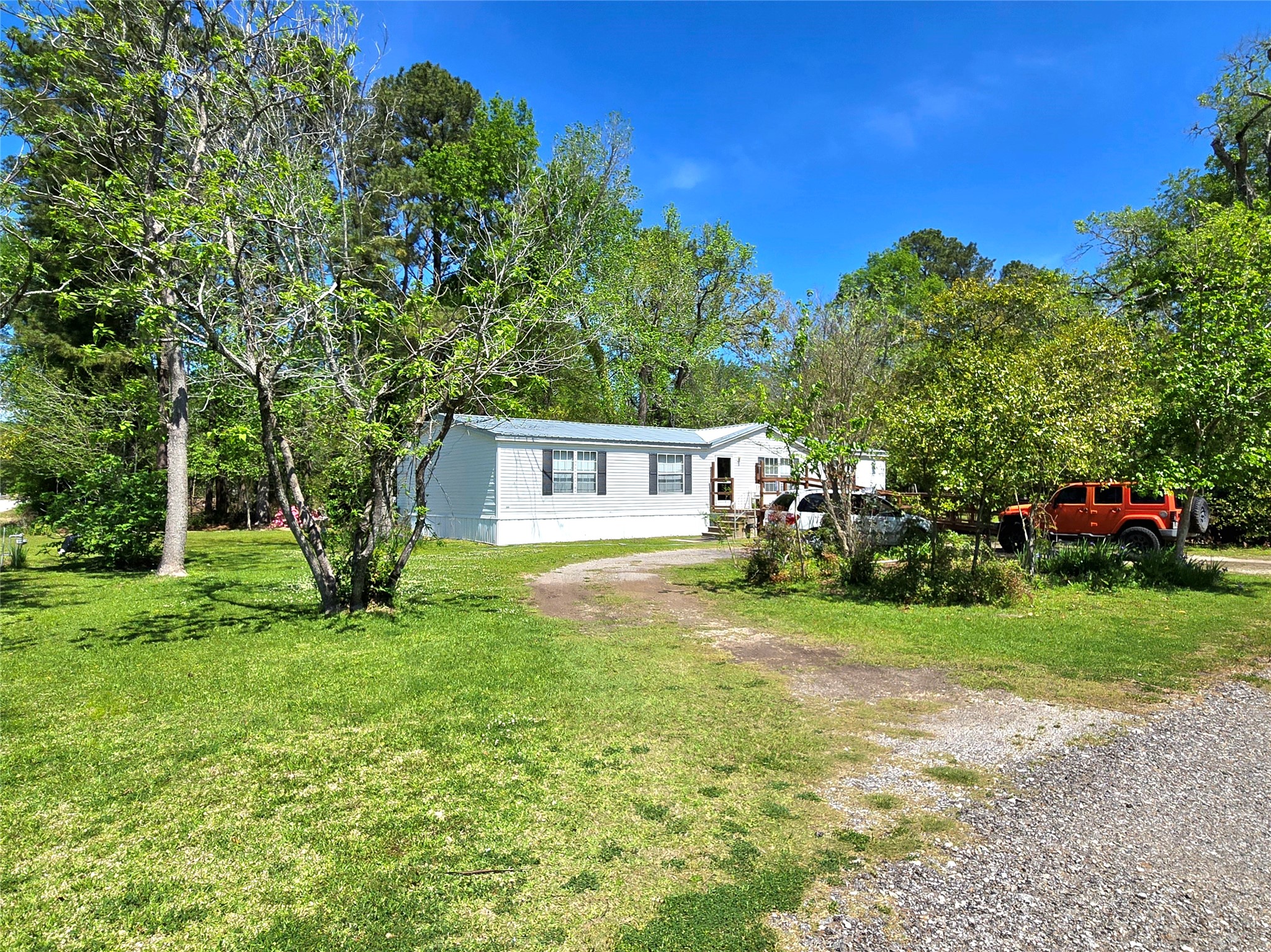 620 Easy Street Cleveland, TX 77327 - Photo 7 of 26 a front view of a house with a garden