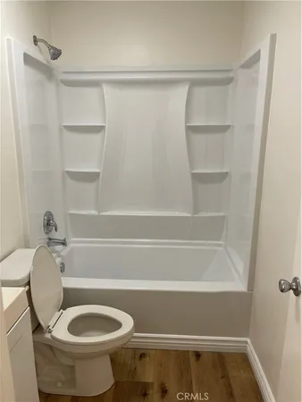 a bathroom with a toilet and a bathtub
