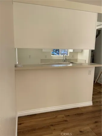 a view of kitchen cabinets and wooden floor
