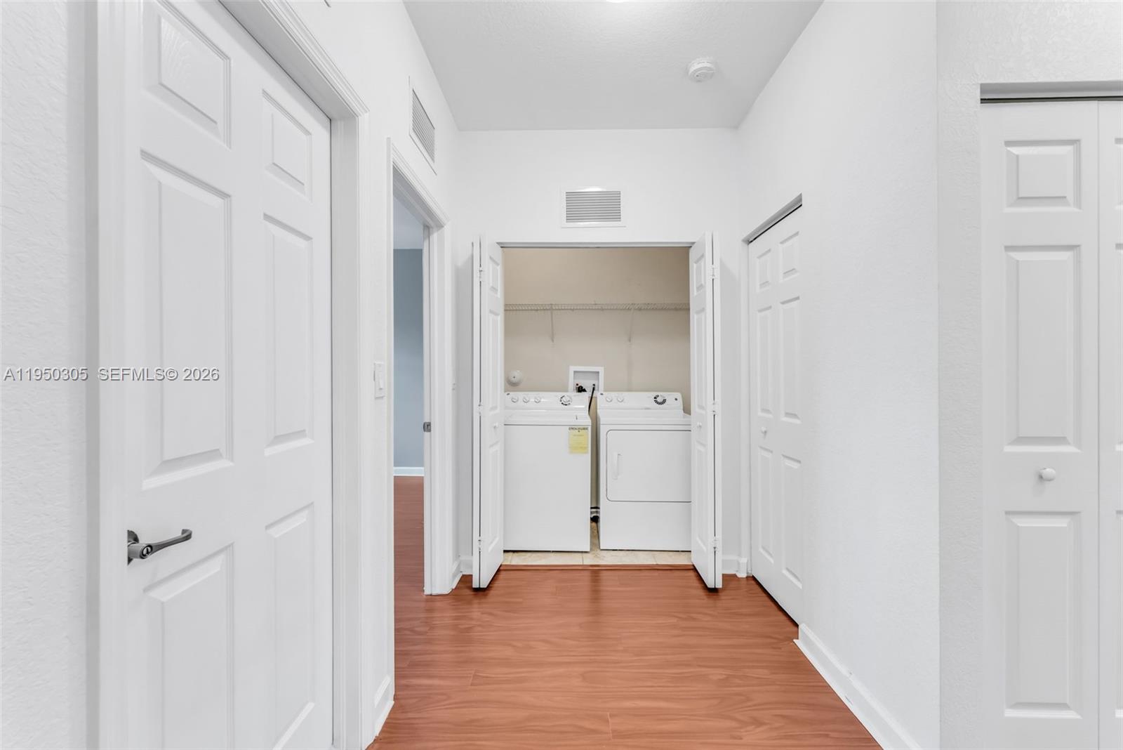 23465 Southwest 113 Passage Homestead, FL 33032 - Photo 16 of 30 wooden floor with white walls