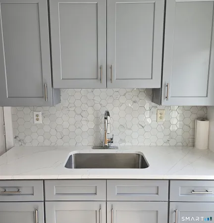 a kitchen with a sink and cabinets
