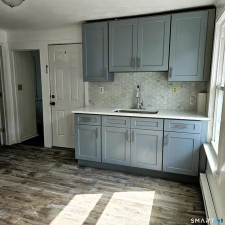 a kitchen with stainless steel appliances granite countertop a sink and cabinets
