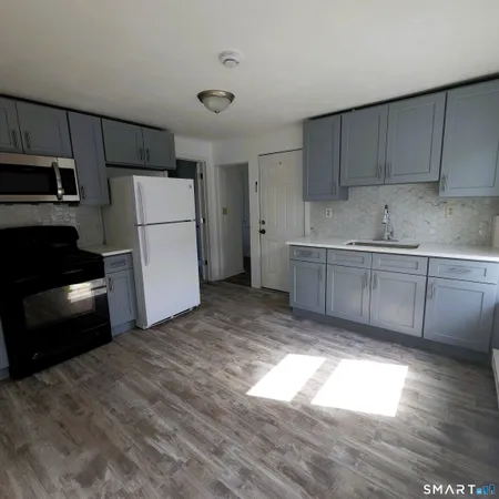 a kitchen with a refrigerator and a sink