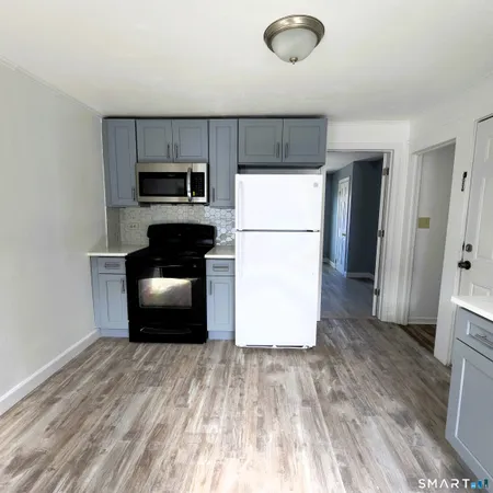 a kitchen with a refrigerator and a stove